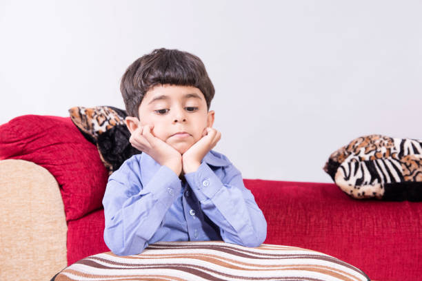 istock Arabic child sitting at home sad 890257600