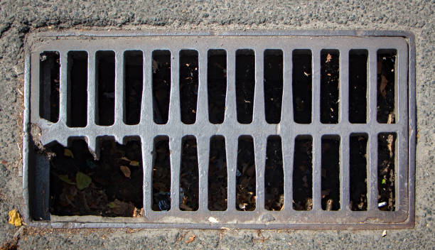 istock Waterfilled pothole on asphalted road 890258034