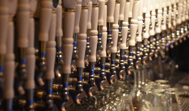 istock Dozens of beer taps in a row 890260392