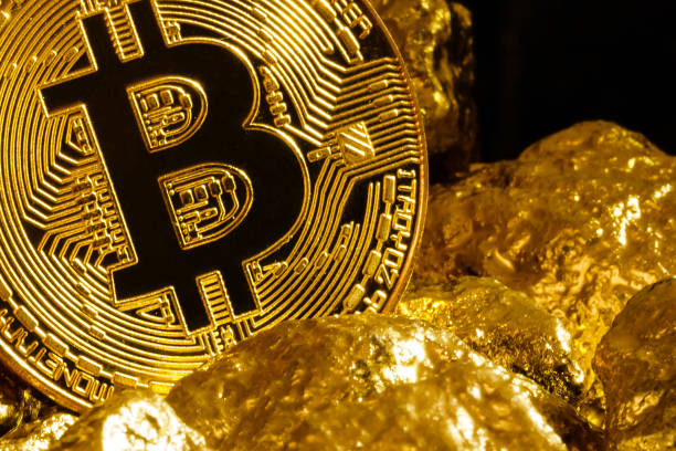 Bitcoin coin and mound of gold nuggets bitcoin cryptocurrency Kiev, Ukraine - December 03, 2017 : Bitcoin coin and mound of gold nuggets bitcoin cryptocurrency gold bitcoin stock pictures, royalty-free photos & images