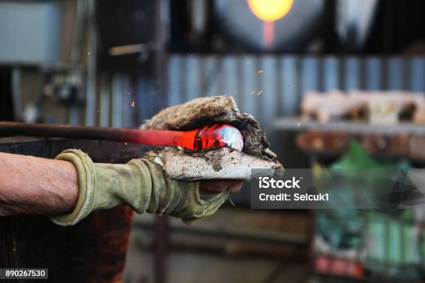 Traditional Glassblowing Worker Cutting Liquid Glass Stock Photo - Download Image Now