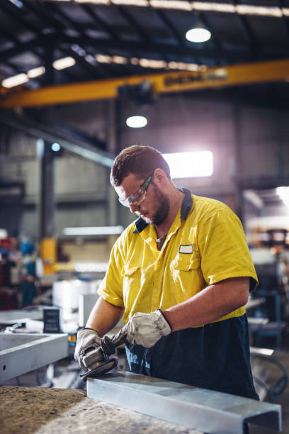 Man working with grinder in Australian manufacturing company stock photo