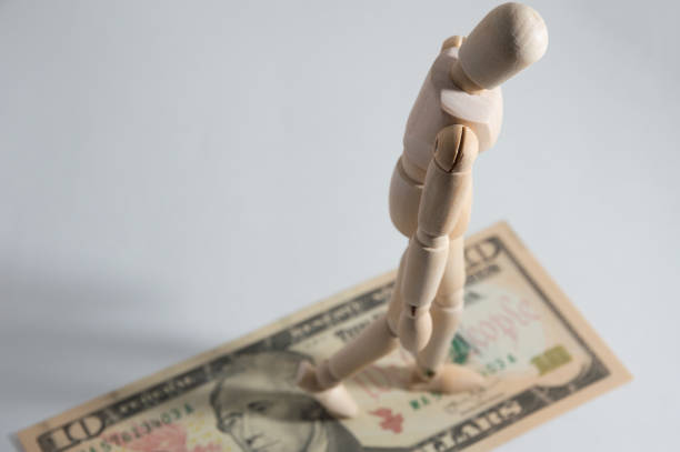 istock Wooden jointed doll on dollar 890273230