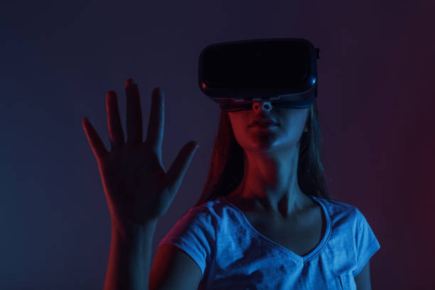 istock Woman with VR gadget touching air 890273300