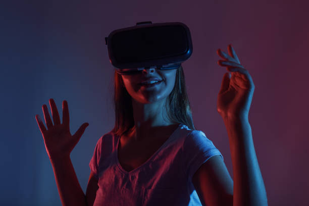 istock Laughing woman with VR goggles 890273454