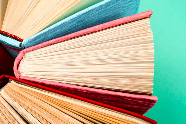 istock Top view of bright colorful hardback books in a circle. 890288008