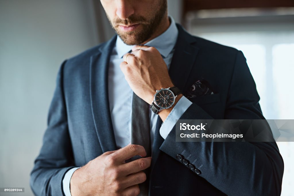 The perfect outfit means a perfect day Shot of an unrecognizable man dressing himself at home Men Stock Photo