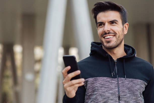 istock Young man texting outdoors 890294528
