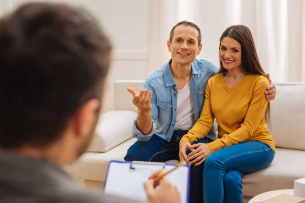istock Young cheerful couple consulting with psychologist 890294538