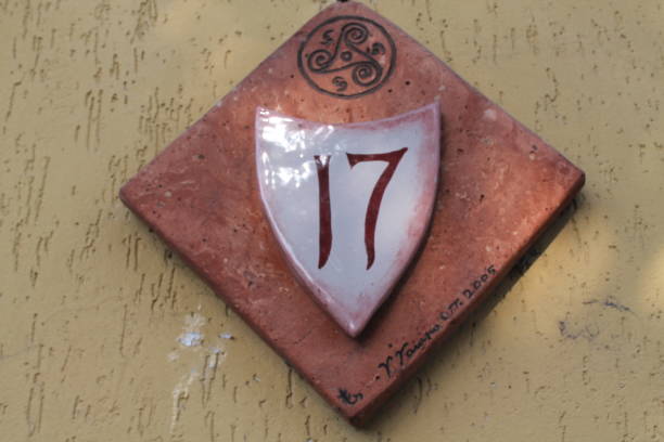 istock Rustic number 17 sign, on a stone marker , on a walking trail 890301326