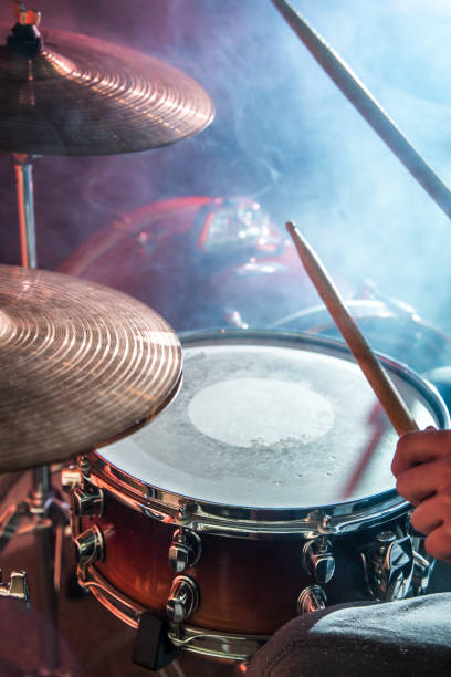 istock man plays the drum, flash of light, a beautiful light in the background with copy space 890305792
