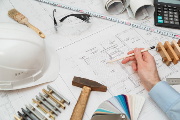 istock Concept architects or engineer holding pencil pointing equipment architects. On the desk with a blueprint in the office. 890315028