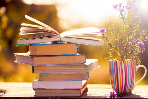 istock Open book on wooden table on natural background. Soft focus 890315070