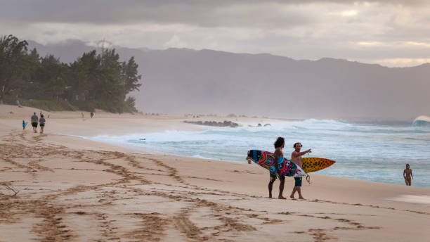 Surfers Walking Banzai Pipeline Hawaii stock photo