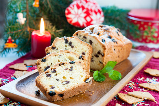 istock Sliced christmas fruitcake with raisins on festive background 890322856