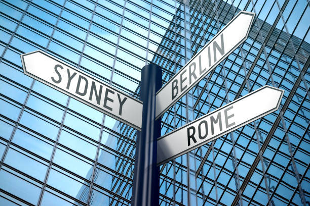 istock Capital cities - crossroads sign, office building 890327526