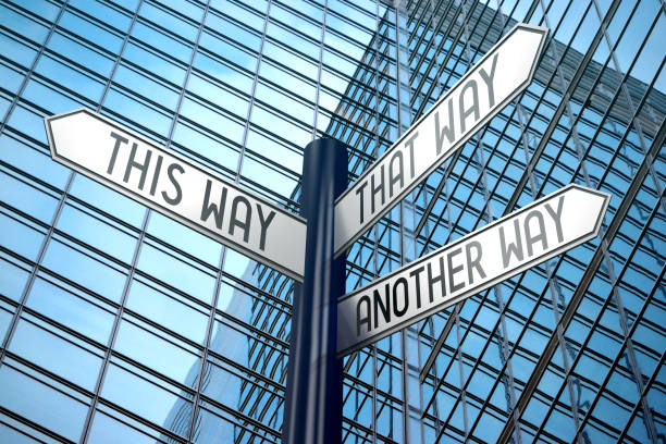 istock This way - crossroads sign, office building 890334534