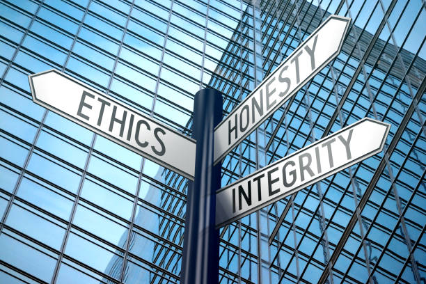 istock Ethics concept - crossroads sign, office building 890337600