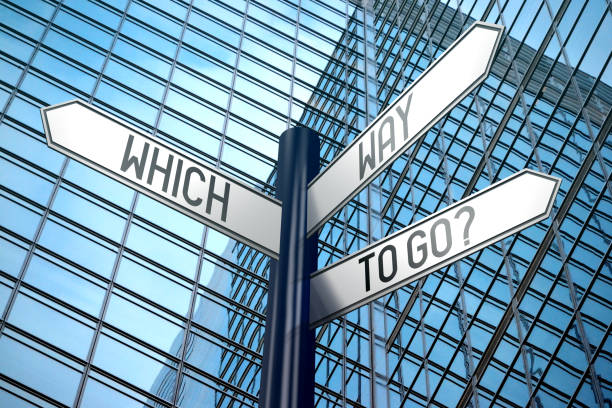 istock Which way to go - crossroads sign, office building 890337632