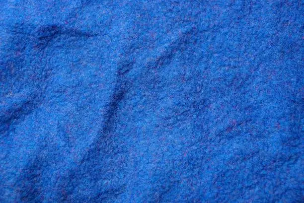 Photo of blue wrinkled woolen cloth from a piece of clothing