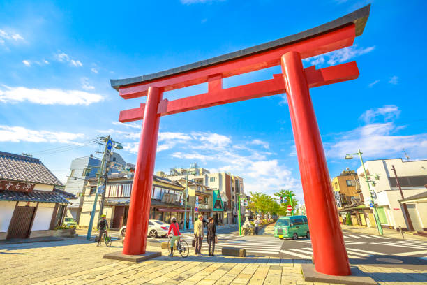 Kamakura, Japan - April 23, 2017: A giant torii gate in the shrine's entrance of Tsurugaoka Hachiman, the most important jinja shinto sanctuary, built in 1063 in ancient Japan.
