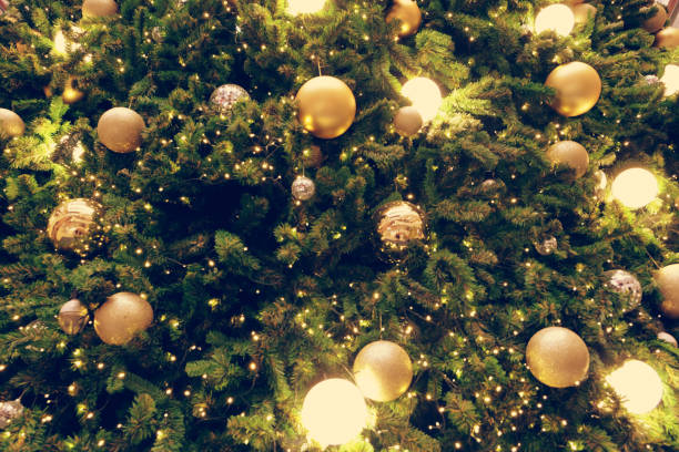 Decorated Christmas tree on blurred, sparkling background stock photo