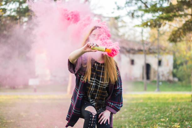 istock Beautiful girl with colored smoke bomb. 890368984