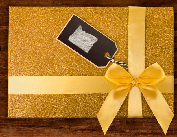 istock A gift box with Oregon drawn on a label with chalk.(series) 890369040