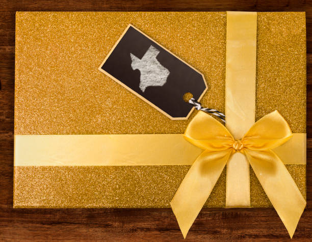 istock A gift box with Texas drawn on a label with chalk.(series) 890369048