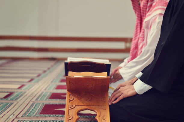istock Two religious muslim man praying together inside the mosque 890369552