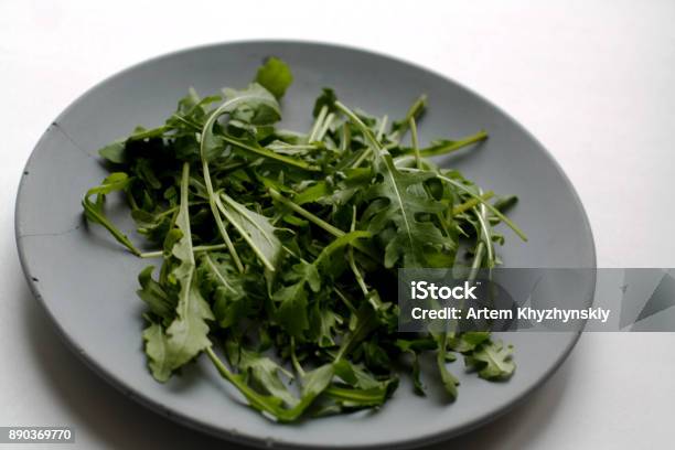 Heap Of Arugula On Plate Stock Photo - Download Image Now - Arugula, Backgrounds, Bunch