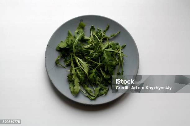 Bundle Of Arugula On Plate From Above Stock Photo - Download Image Now - Arugula, Backgrounds, Bunch