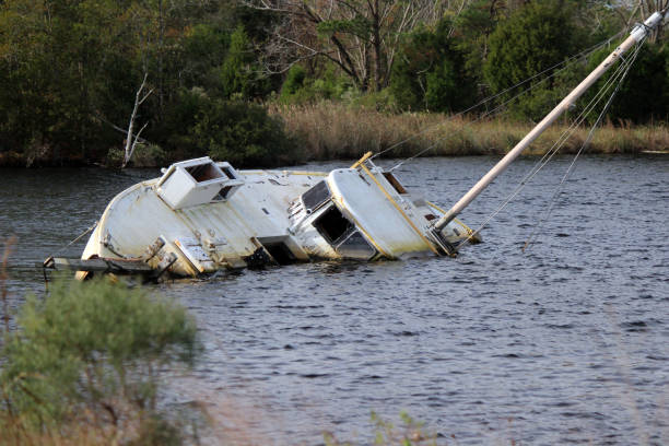 A ship wreck on sea half down in the water.