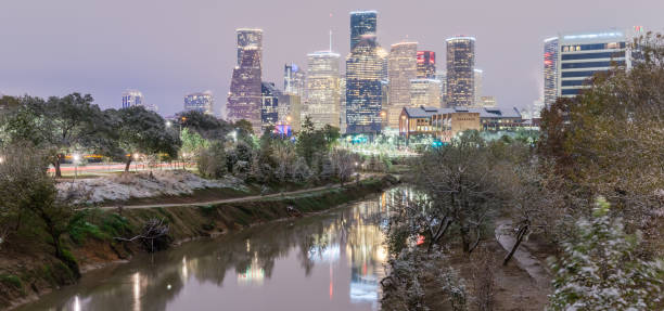 istock Snowfall along Bayou River bank and downtown Houston 890372714