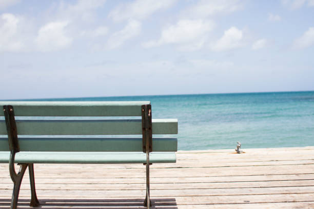 Closeup bench on pier in Grenada stock photo