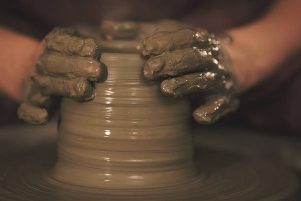 istock Female pottery artist making a shape from clay 890377378