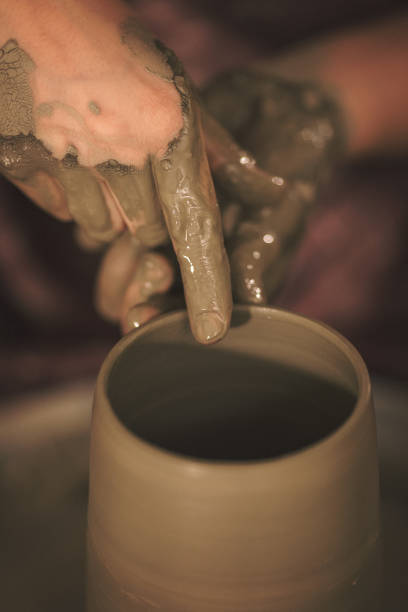 istock Female pottery artist making a shape from clay 890377680