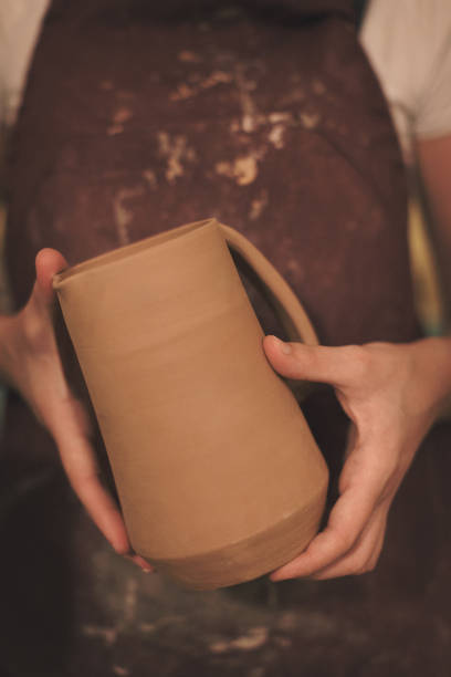 istock Female pottery artist making a shape from clay 890380218