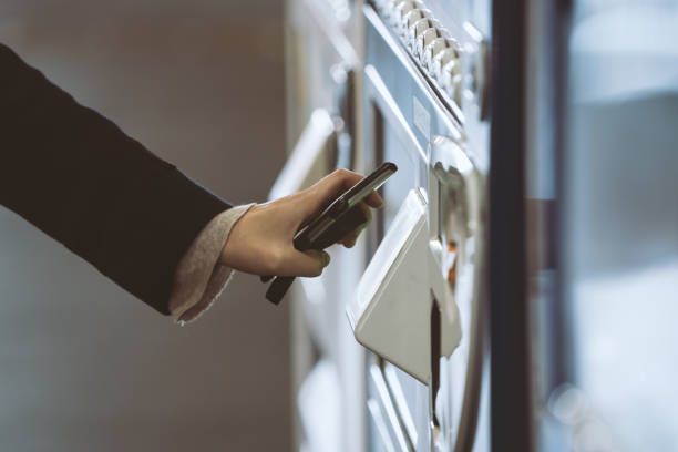 Woman buying with a vending machine