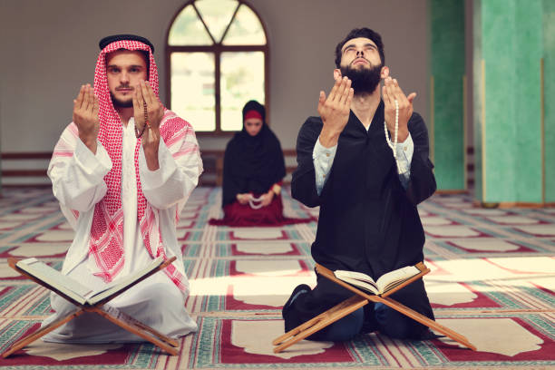istock Two religious muslim man praying together inside the mosque 890380352