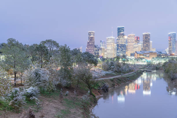 istock Snowfall along Bayou River bank and downtown Houston 890382702