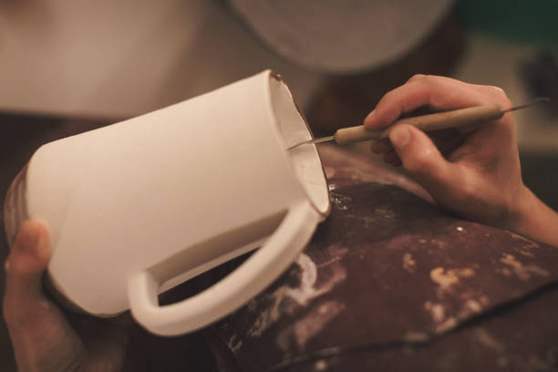 istock Female pottery artist making a shape from clay 890382772