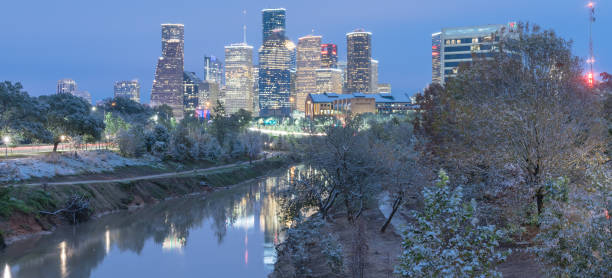 istock Snowfall along Bayou River bank and downtown Houston 890383162