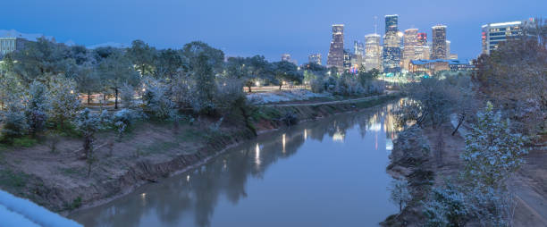 istock Snowfall along Bayou River bank and downtown Houston 890383320