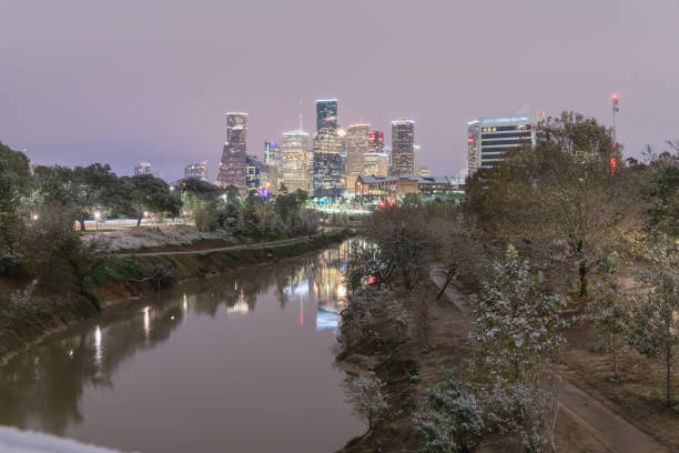 istock Snowfall along Bayou River bank and downtown Houston 890383458