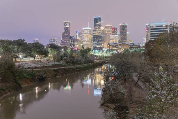istock Snowfall along Bayou River bank and downtown Houston 890383538