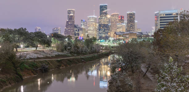 istock Snowfall along Bayou River bank and downtown Houston 890383592