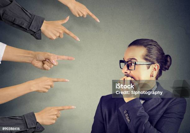 Anxious Man Scared Of Being Judged By Different People Concept Of Accusation Of Guilty Guy Negative Emotions Face Expression Feeling Stock Photo - Download Image Now