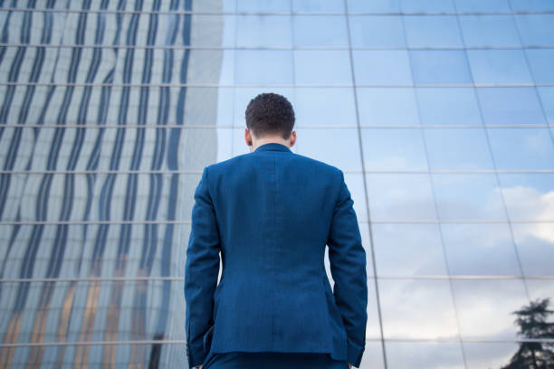 istock Anonymous elegant man against contemporary building 890393016