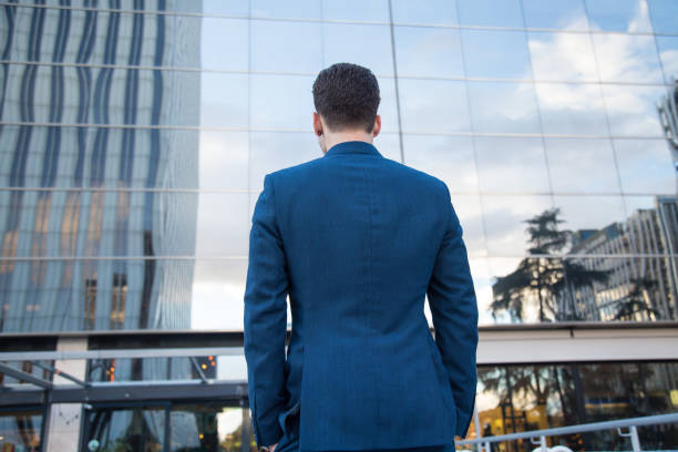 istock Anonymous elegant man against contemporary building 890393018